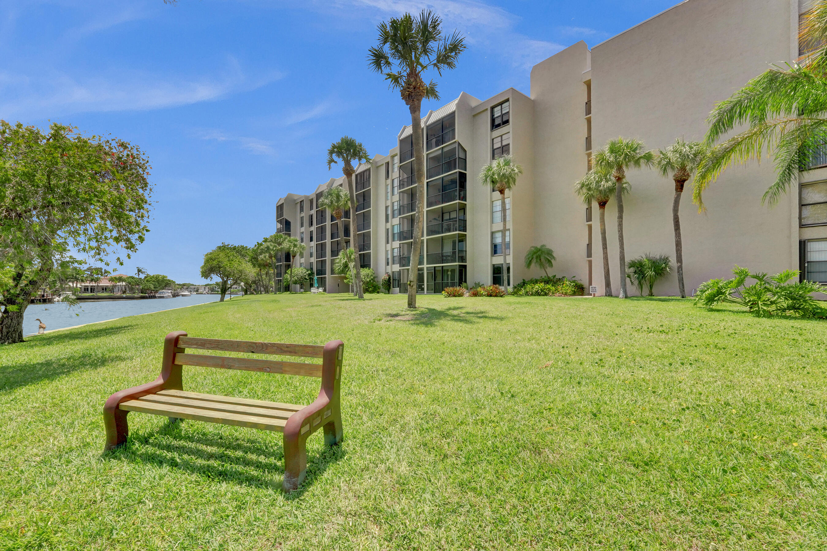 12 Royal Palm Way, Unit 6020 Boca Raton, FL 33432 - Photo 38 of 69 a garden view with a bench in front of house