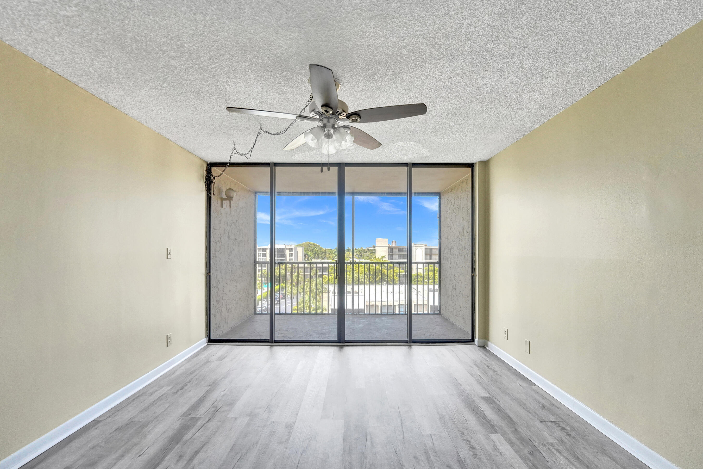 12 Royal Palm Way, Unit 6020 Boca Raton, FL 33432 - Photo 6 of 69 an empty room with wooden floor and windows