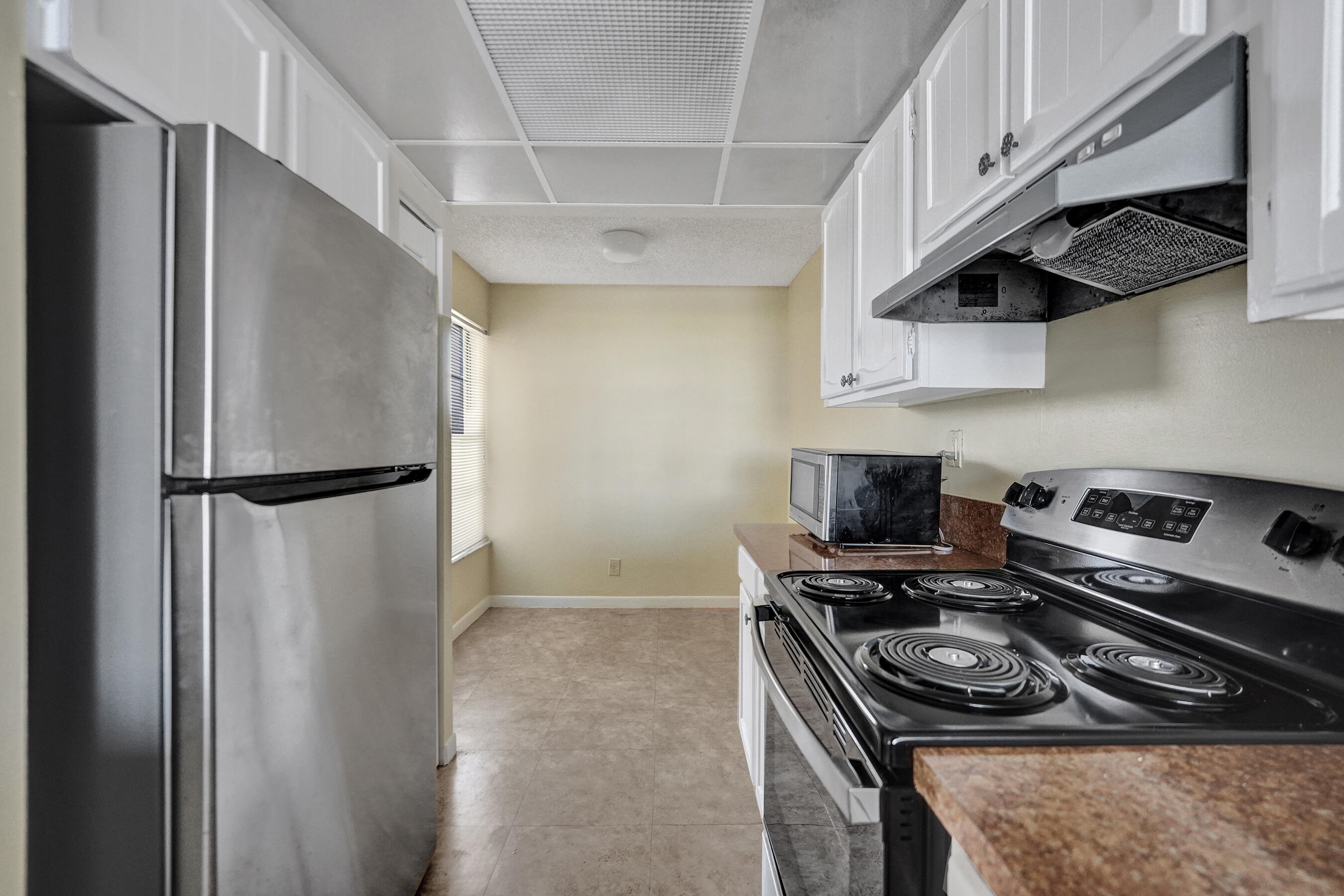 12 Royal Palm Way, Unit 6020 Boca Raton, FL 33432 - Photo 61 of 69 a kitchen with stainless steel appliances granite countertop a stove and a refrigerator
