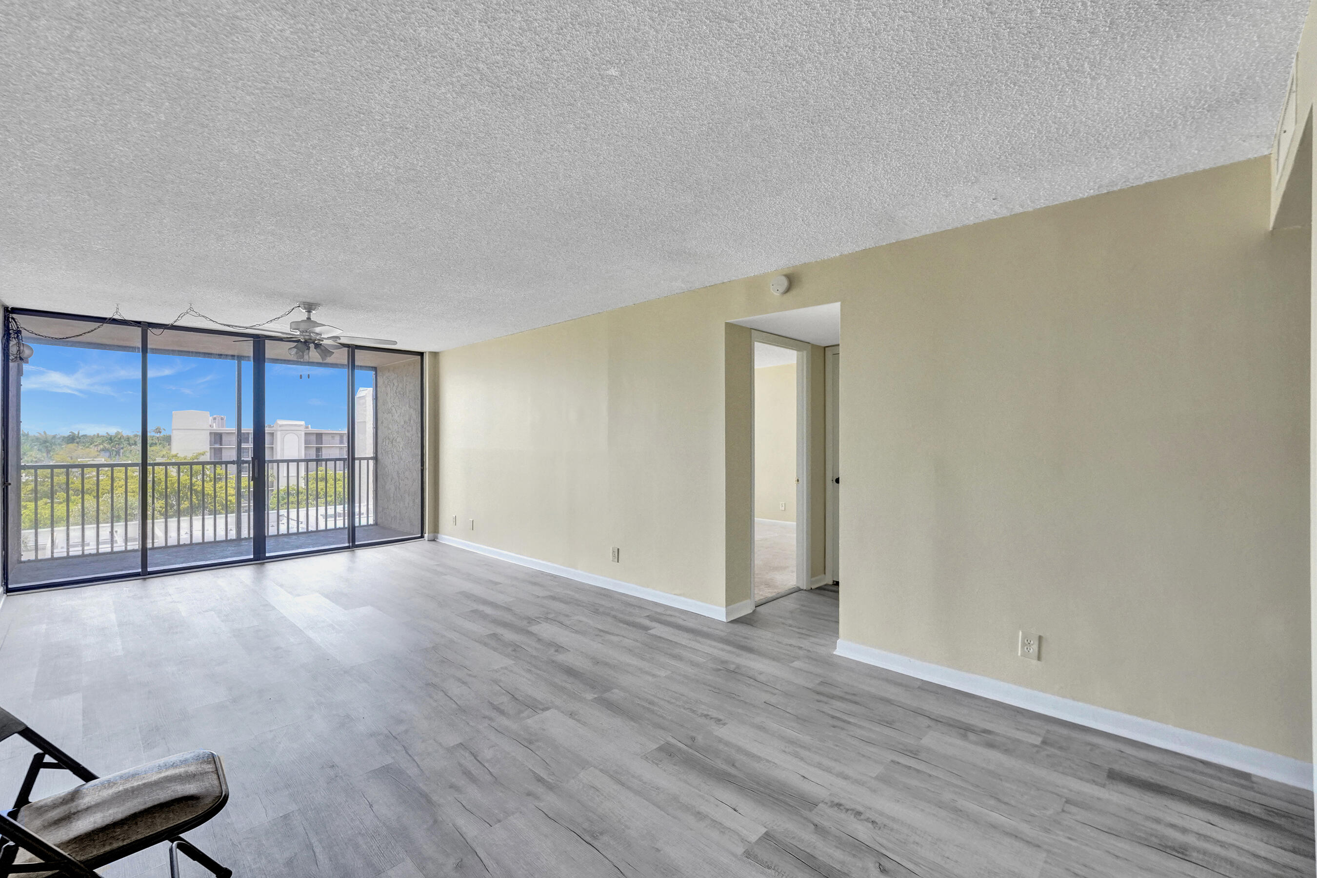 12 Royal Palm Way, Unit 6020 Boca Raton, FL 33432 - Photo 10 of 69 a view of an empty room with wooden floor and a window
