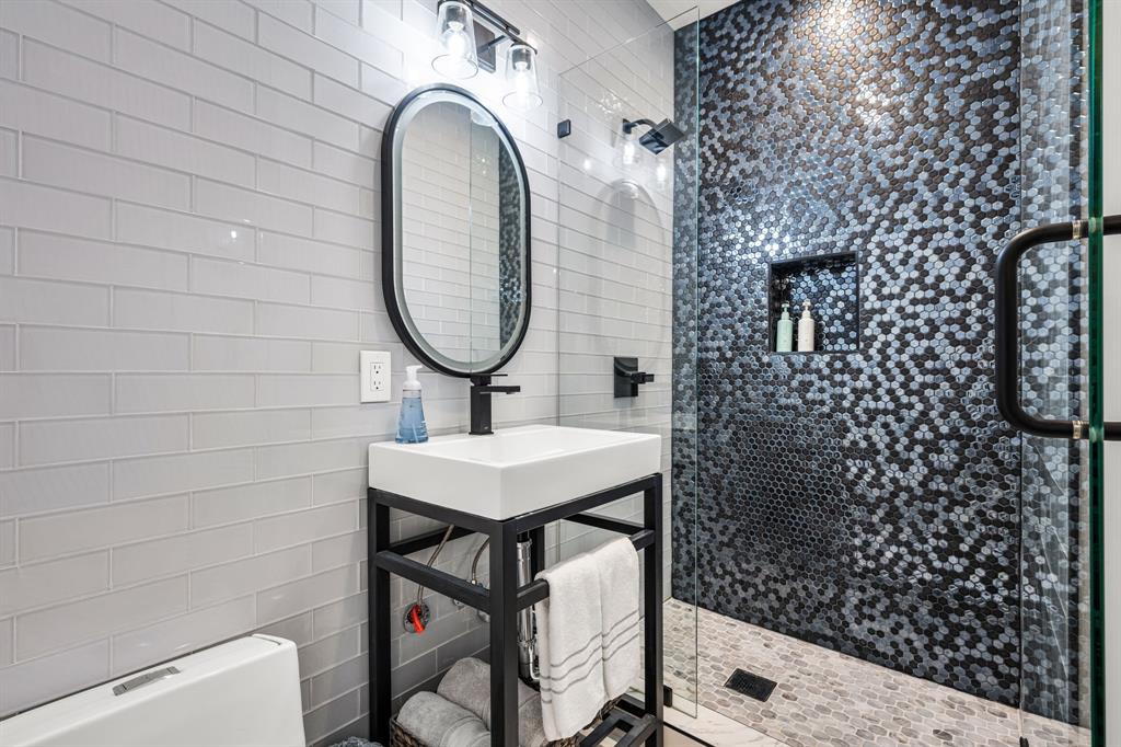 2214 Allen Street, Unit A Dallas, TX 75204 - Photo 13 of 36 a bathroom with a sink a toilet and shower