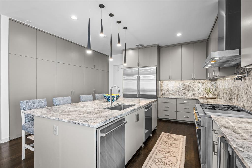 2214 Allen Street, Unit A Dallas, TX 75204 - Photo 18 of 36 a kitchen that has a sink a stove and a wooden floor