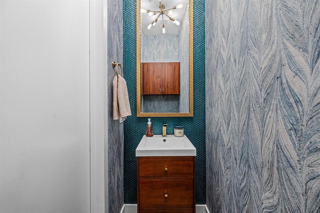 2214 Allen Street, Unit A Dallas, TX 75204 - Photo 25 of 36 a bathroom with a sink and a mirror