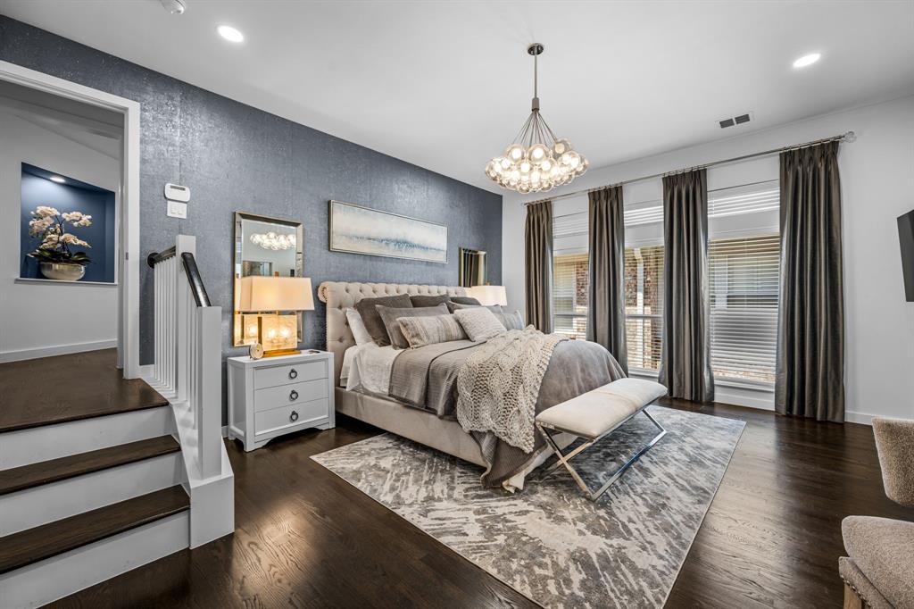 2214 Allen Street, Unit A Dallas, TX 75204 - Photo 26 of 36 a spacious bedroom with a bed and a chandelier
