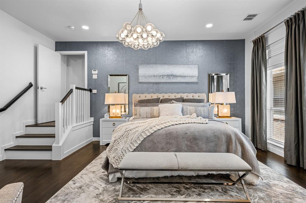 2214 Allen Street, Unit A Dallas, TX 75204 - Photo 27 of 36 a bedroom with a large bed and a chandelier
