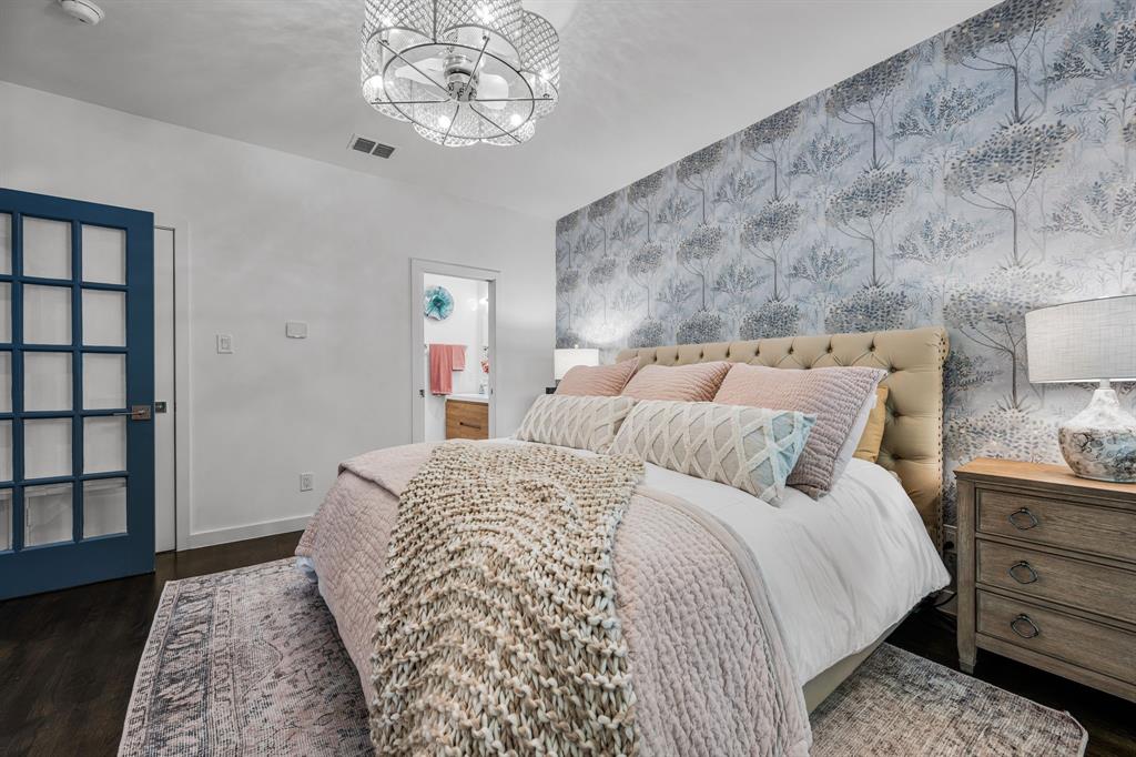 2214 Allen Street, Unit A Dallas, TX 75204 - Photo 9 of 36 a bed room with a bed and a chandelier