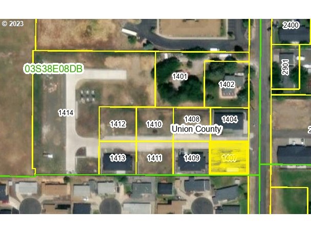 a view of a street with a building and a street sign