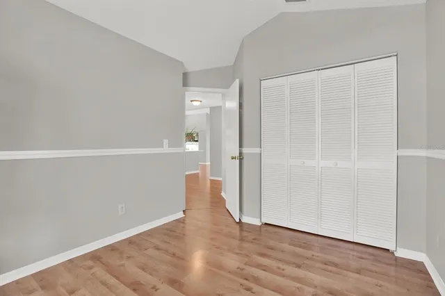 an empty room with wooden floor