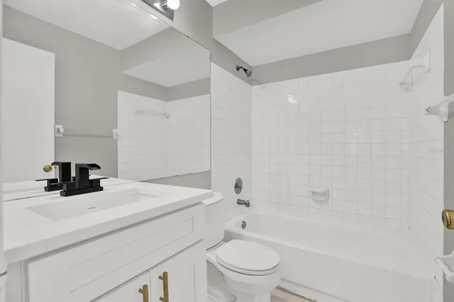 a bathroom with a sink a toilet and a bathtub