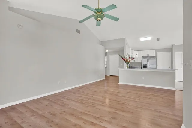 a view of kitchen with refrigerator and a sink
