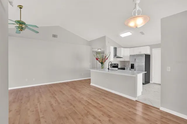 a view of kitchen with stainless steel appliances granite countertop refrigerator sink and stove