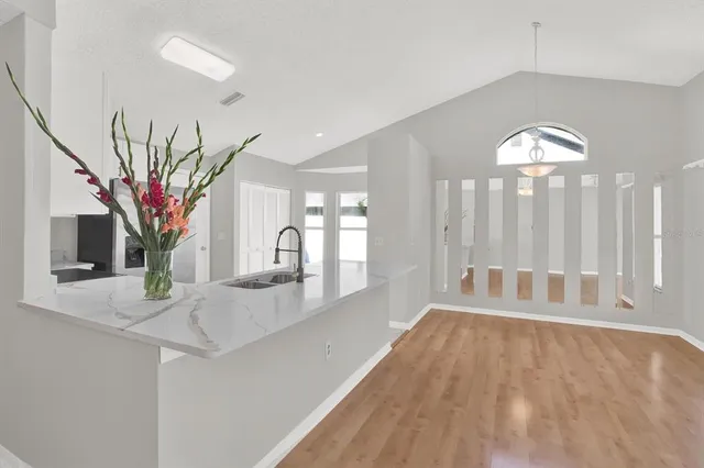 a view of a living room with hardwood floor and a large window