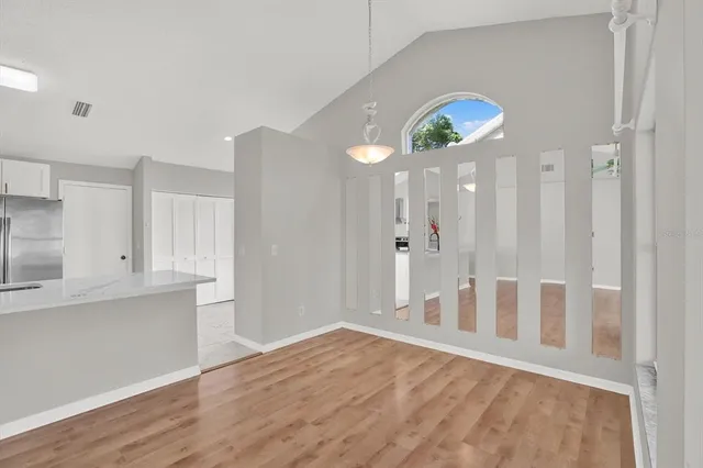 a view of empty room with wooden floor