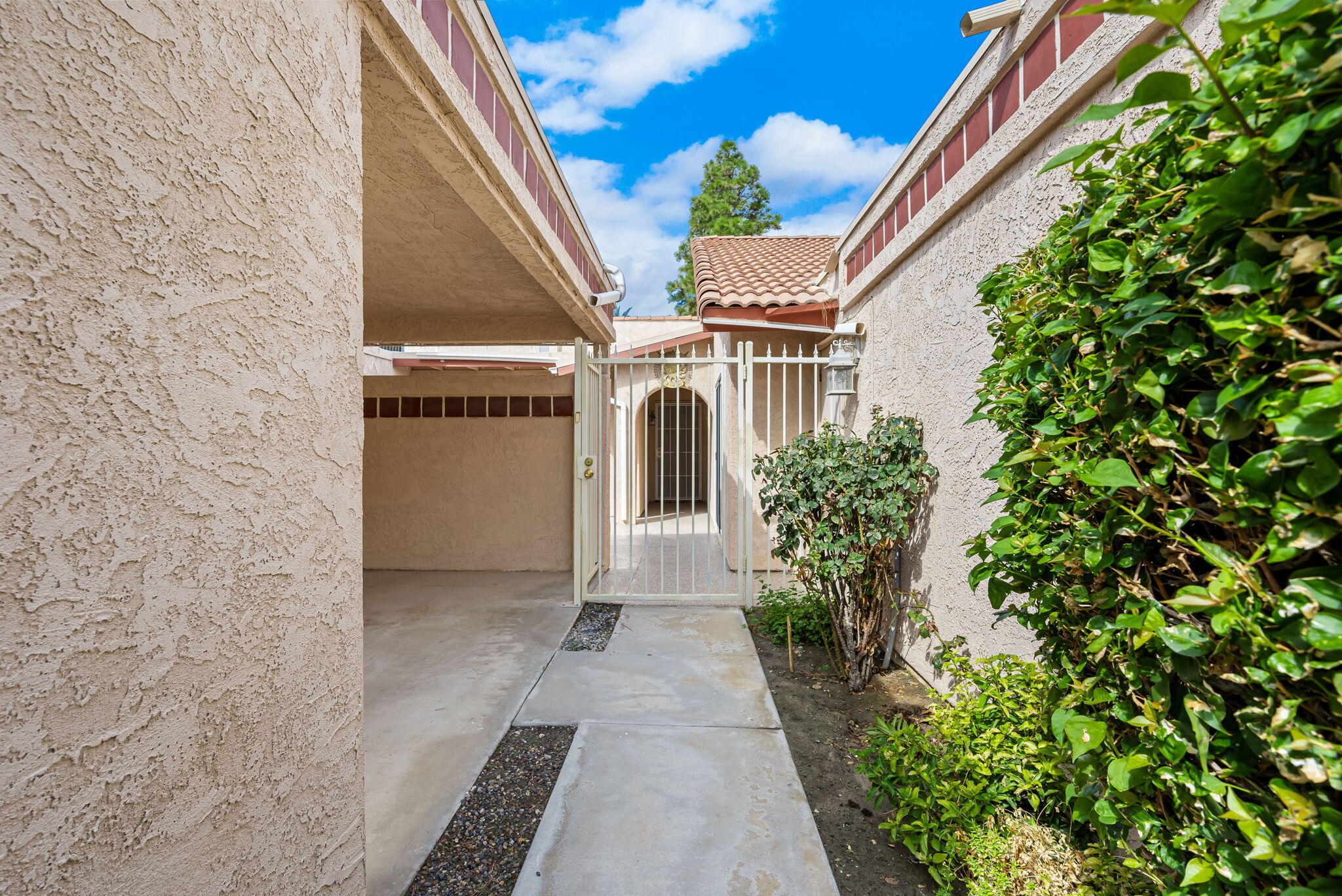 49101 Taylor Street Indio, CA 92201 - Photo 11 of 47 a entryway with a flower plants