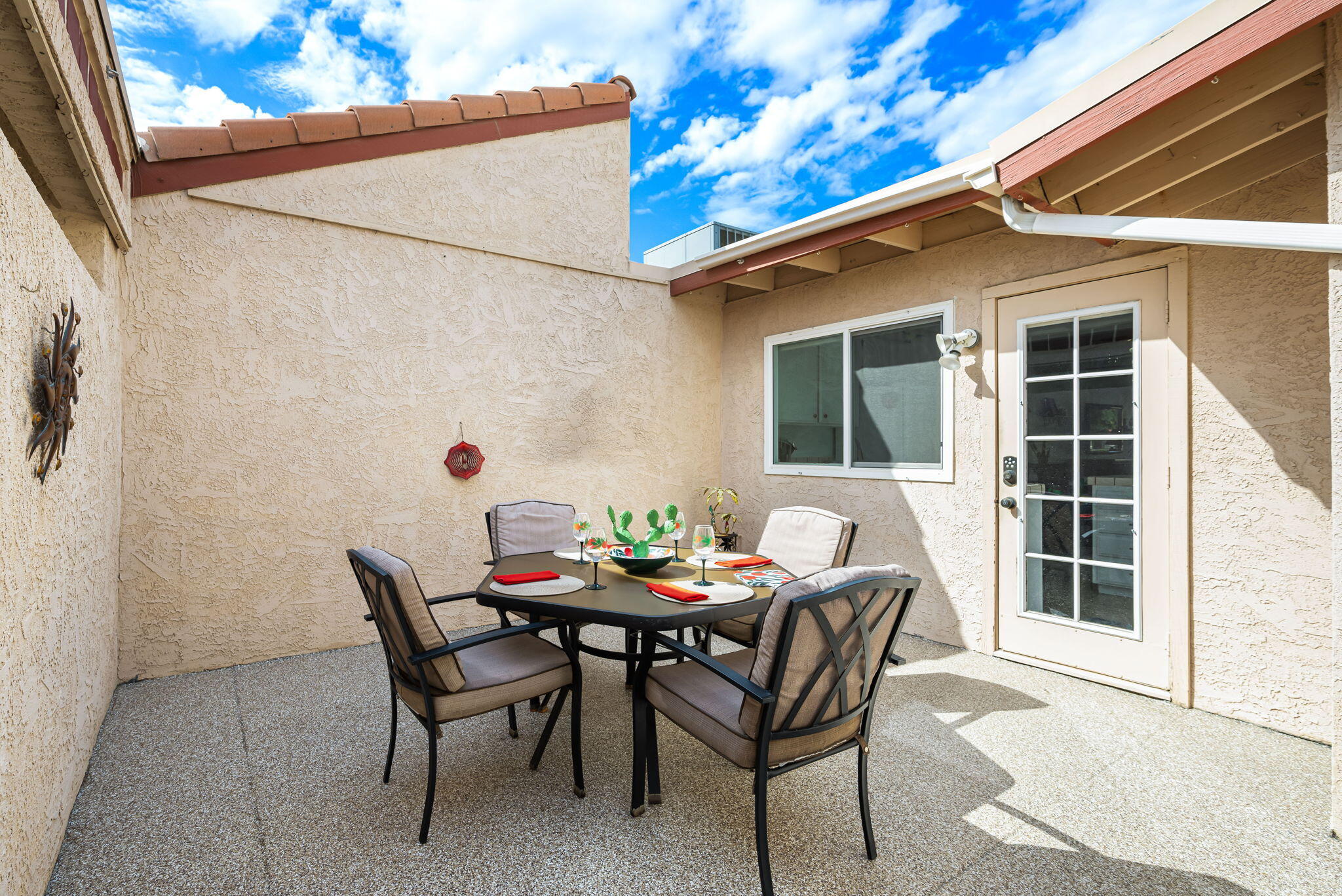 49101 Taylor Street Indio, CA 92201 - Photo 13 of 47 a patio with a table and chairs and potted plants