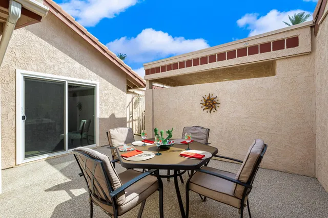 a outdoor space with a table and chairs