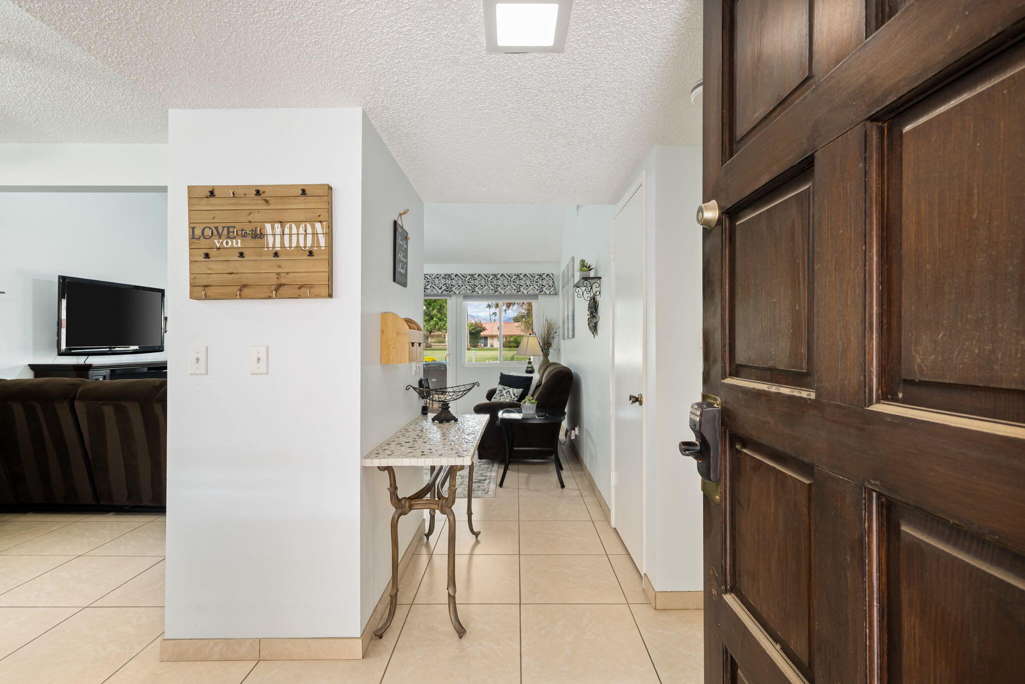 49101 Taylor Street Indio, CA 92201 - Photo 16 of 47 a living room with furniture and a flat screen tv