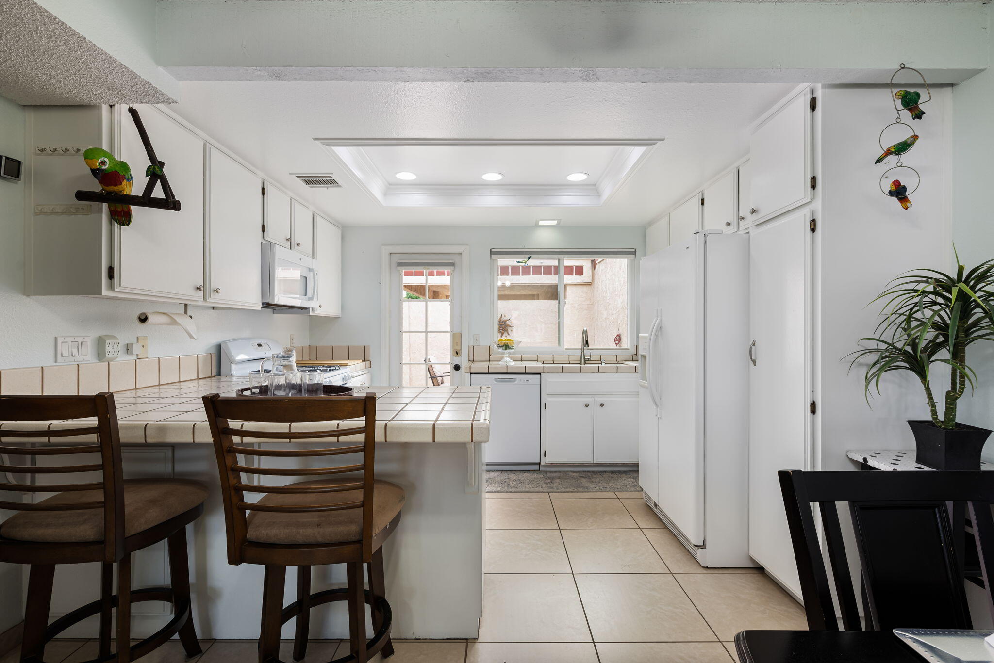 49101 Taylor Street Indio, CA 92201 - Photo 21 of 47 a kitchen with a refrigerator and white cabinets