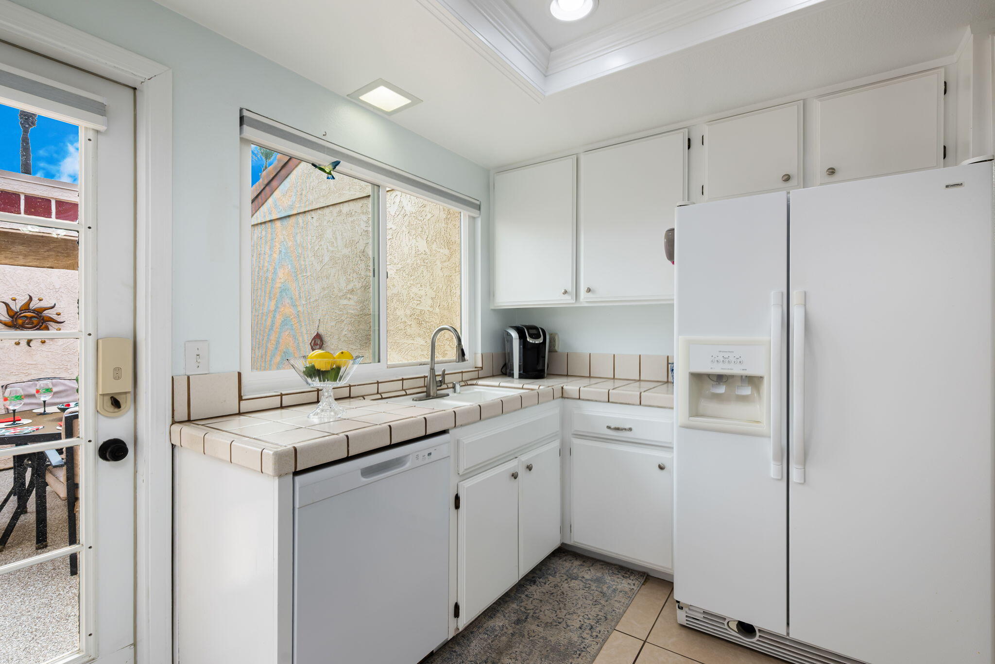 49101 Taylor Street Indio, CA 92201 - Photo 24 of 47 a kitchen with a white cabinets and white appliances