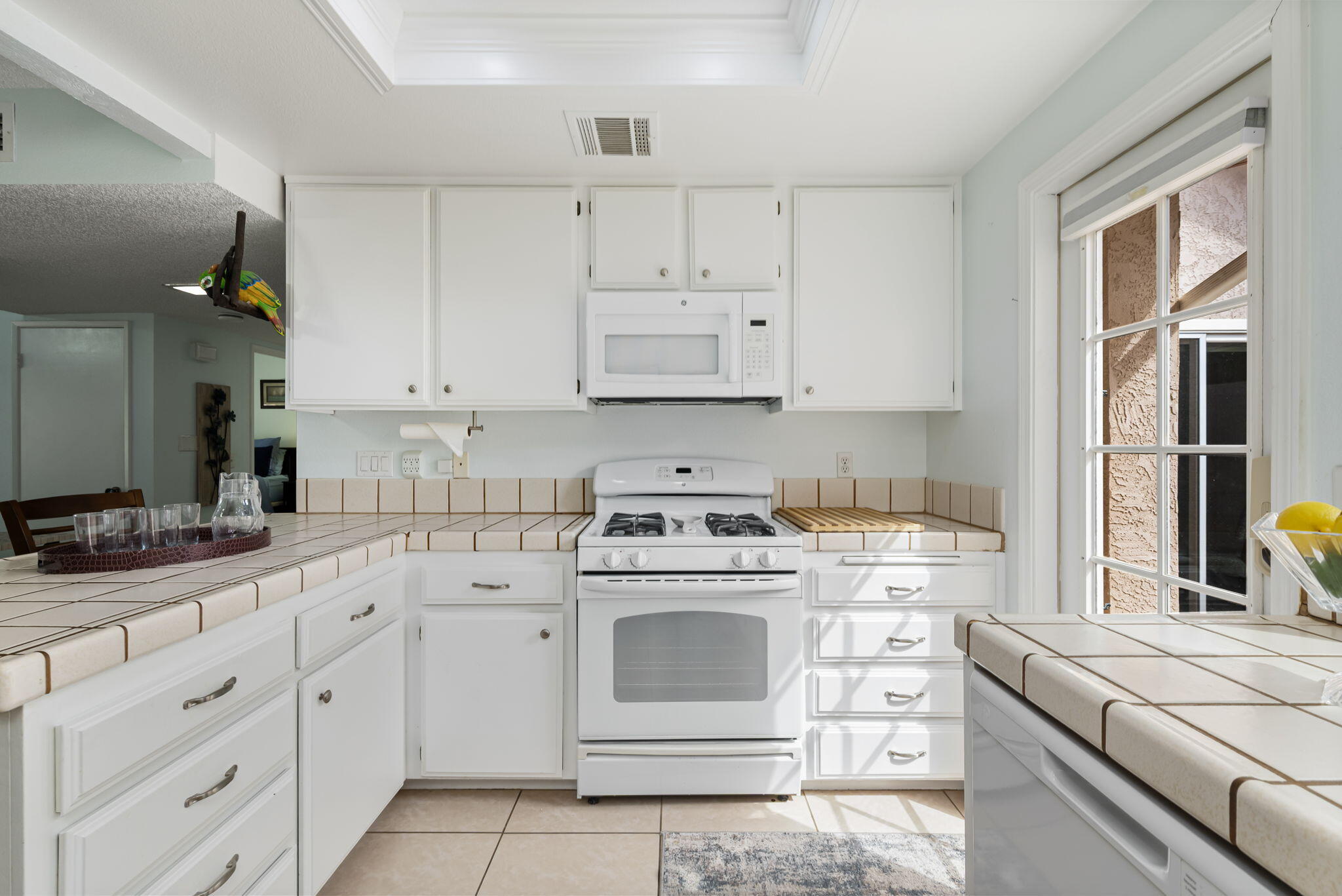 49101 Taylor Street Indio, CA 92201 - Photo 28 of 47 a kitchen with cabinets appliances a sink and a counter top space