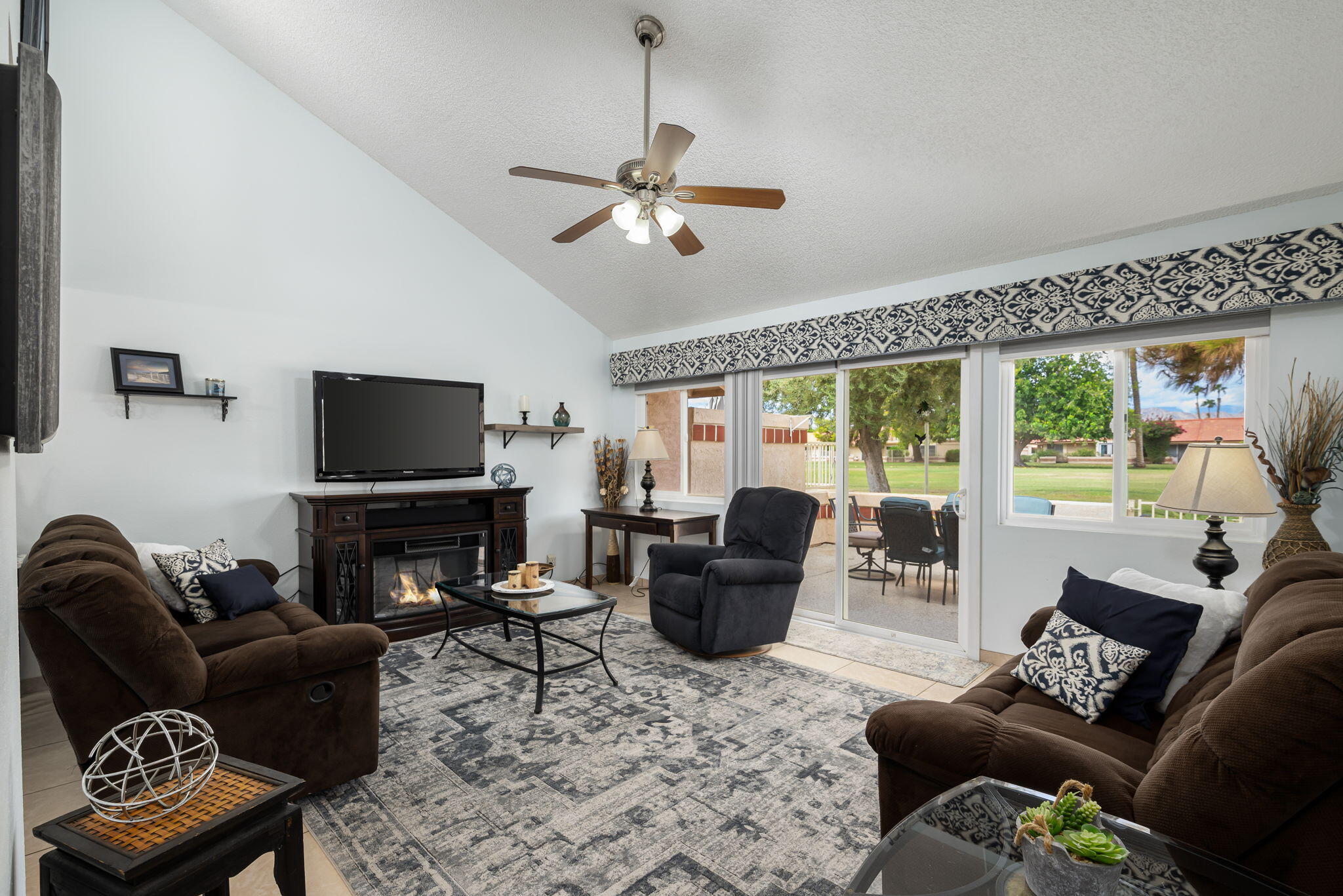 49101 Taylor Street Indio, CA 92201 - Photo 30 of 47 a living room with furniture a flat screen tv and a large window