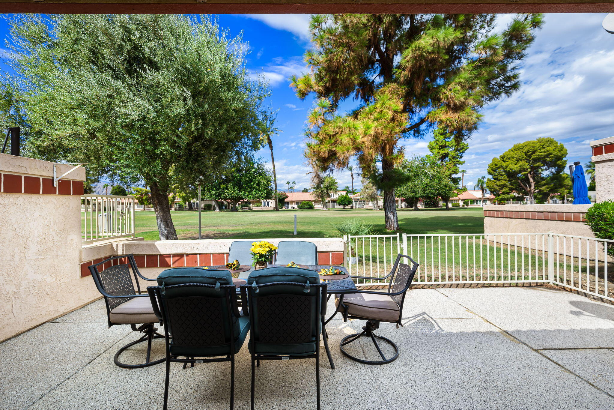 49101 Taylor Street Indio, CA 92201 - Photo 33 of 47 a view of a patio with a table chairs and a yard