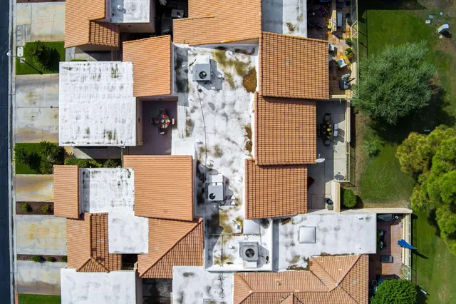 an aerial view of residential houses with outdoor space