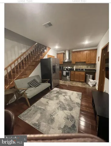 a kitchen with a sink a stove a refrigerator and cabinets