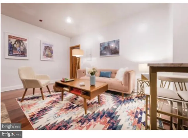 a living room with furniture and a rug