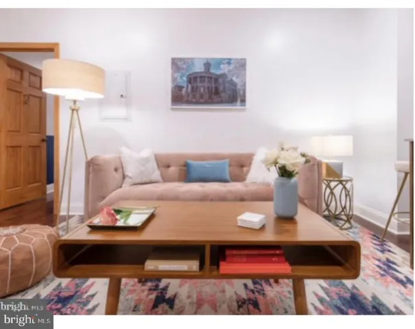 a living room with furniture and a rug