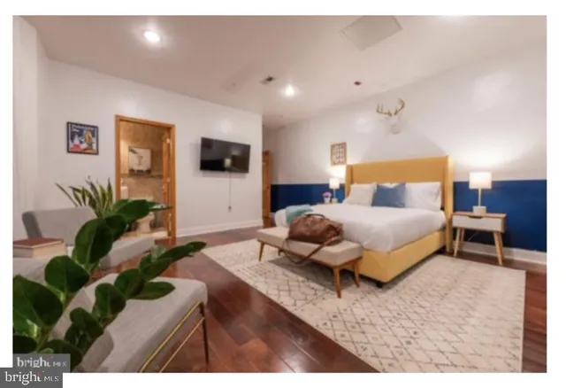 a bedroom with a bed and a flat screen tv