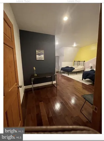 a bathroom with a granite countertop sink and a toilet