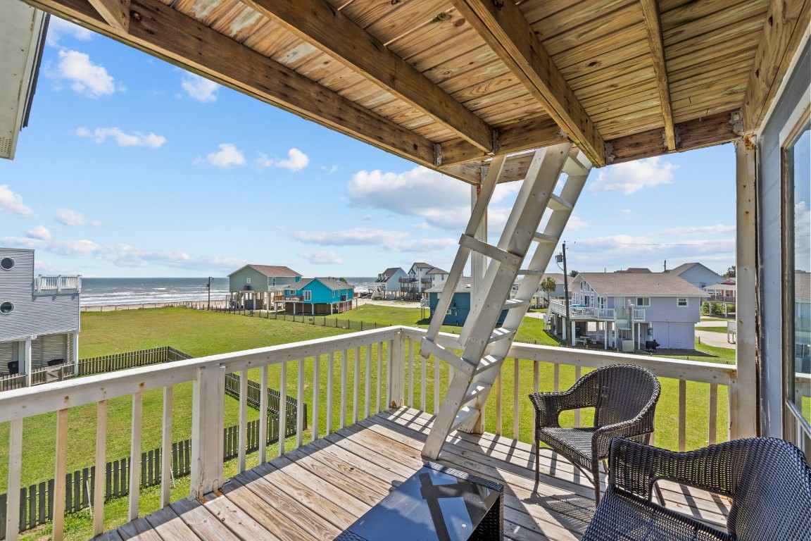 17729 Termini-San Luis Pass Road Galveston, TX 77554 - Photo 14 of 36 a view of a city from a balcony with chairs