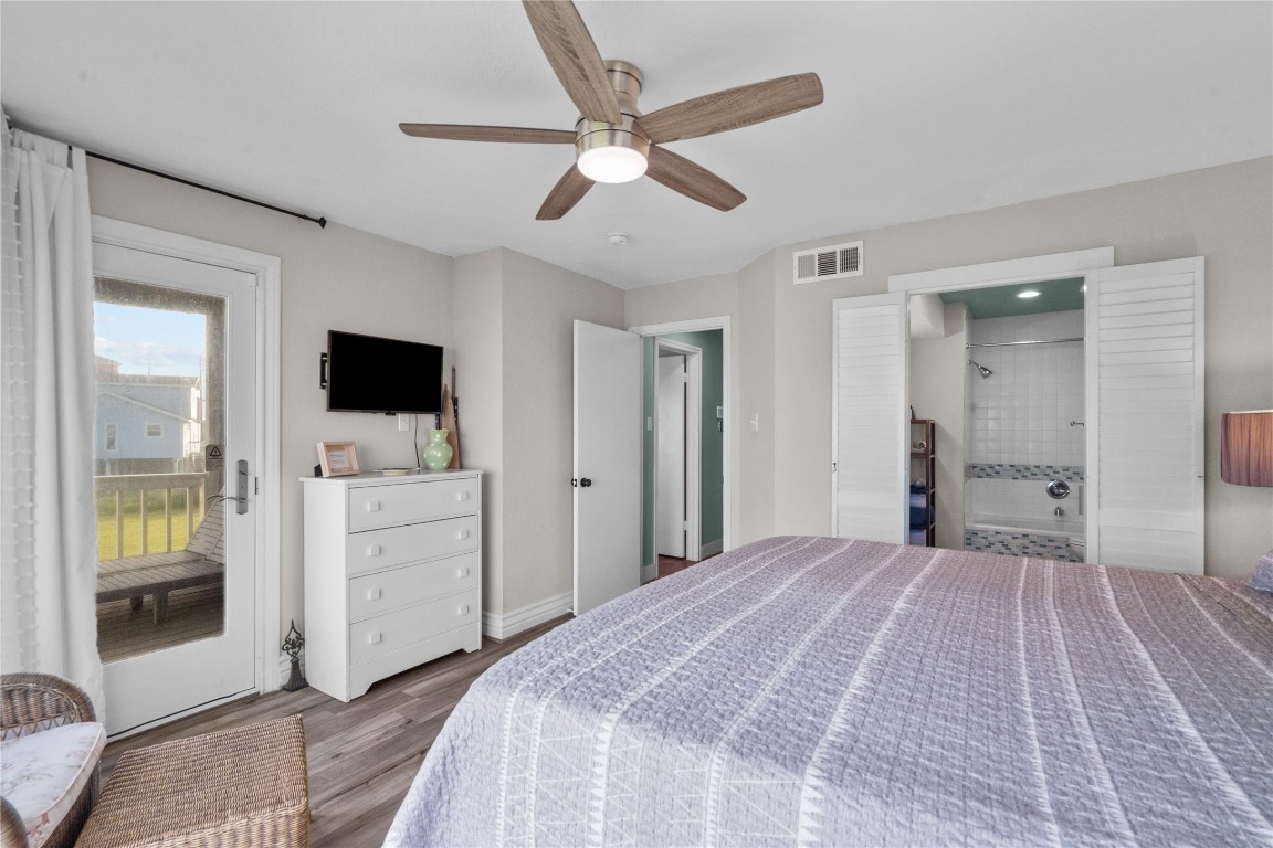 17729 Termini-San Luis Pass Road Galveston, TX 77554 - Photo 19 of 36 a bedroom with a bed and a flat screen tv