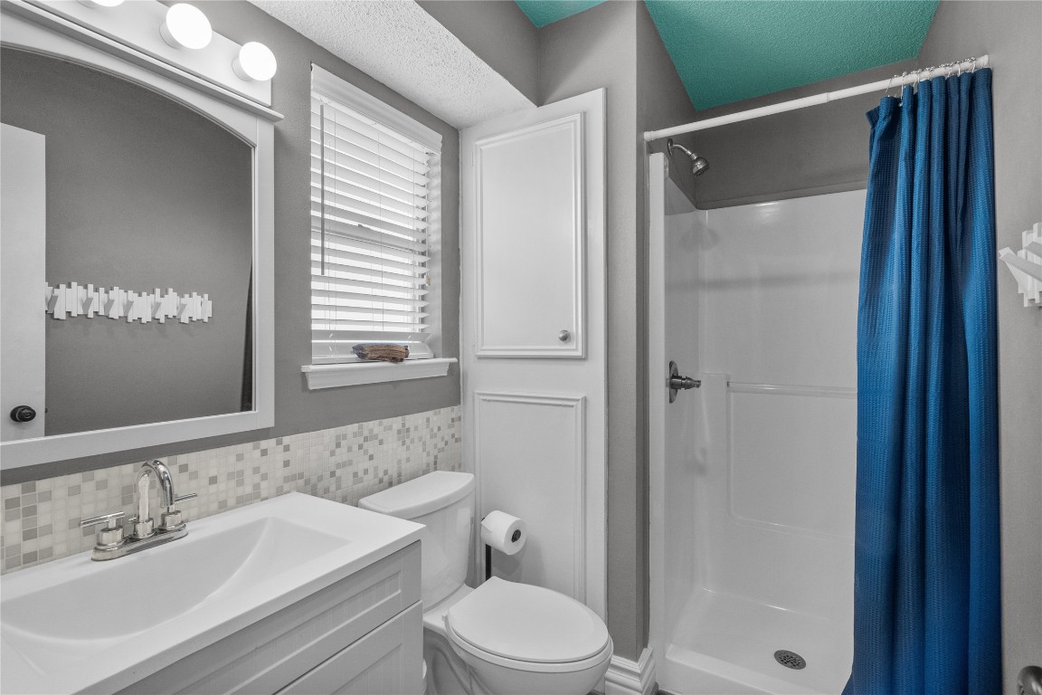 17729 Termini-San Luis Pass Road Galveston, TX 77554 - Photo 28 of 36 a bathroom with a sink a toilet and shower