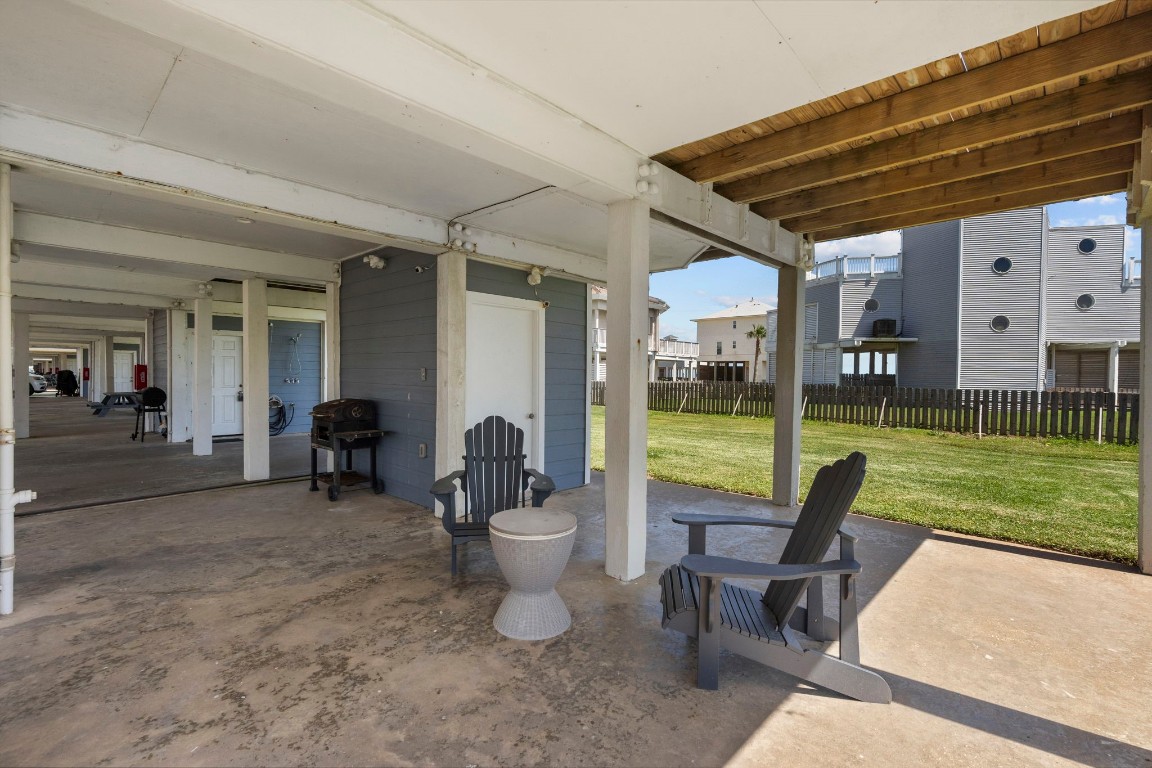 17729 Termini-San Luis Pass Road Galveston, TX 77554 - Photo 34 of 36 a view of a patio with a table chairs and a yard