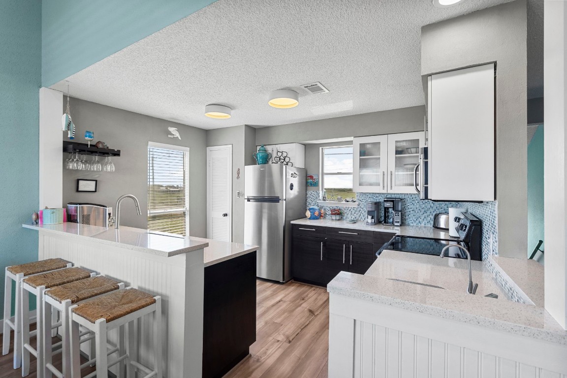 17729 Termini-San Luis Pass Road Galveston, TX 77554 - Photo 9 of 36 a kitchen with a sink stove and refrigerator