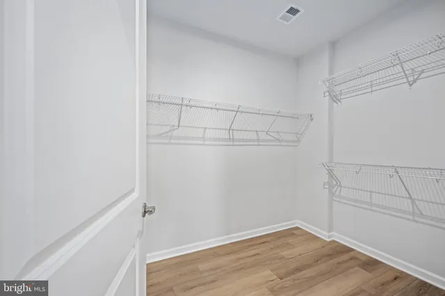 a spacious bathroom with a double vanity sink mirror and shower