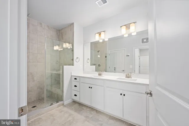 a bathroom with a shower sink and mirror