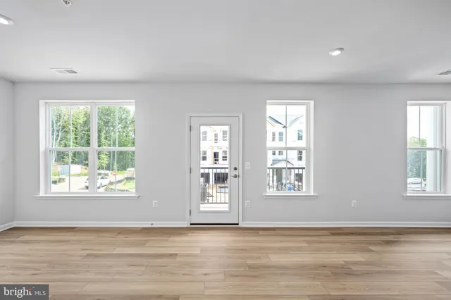 a view of wooden floor and windows in a room