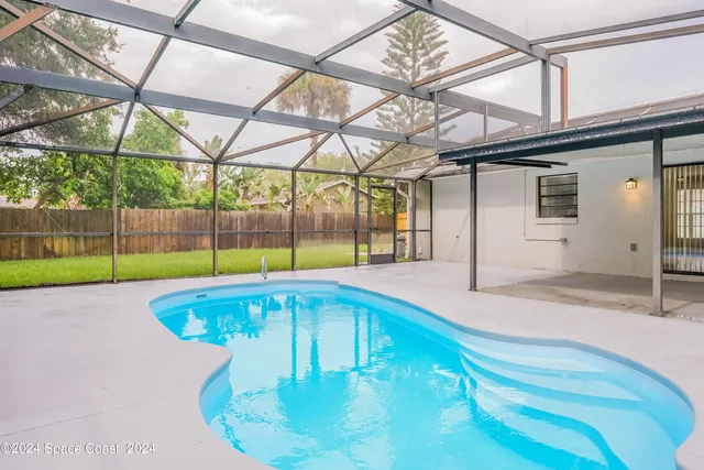 a view of a backyard with a garden and entertaining space