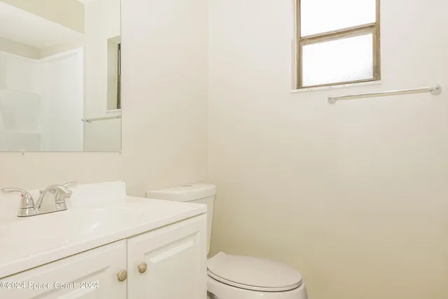 a bathroom with a sink a toilet and mirror
