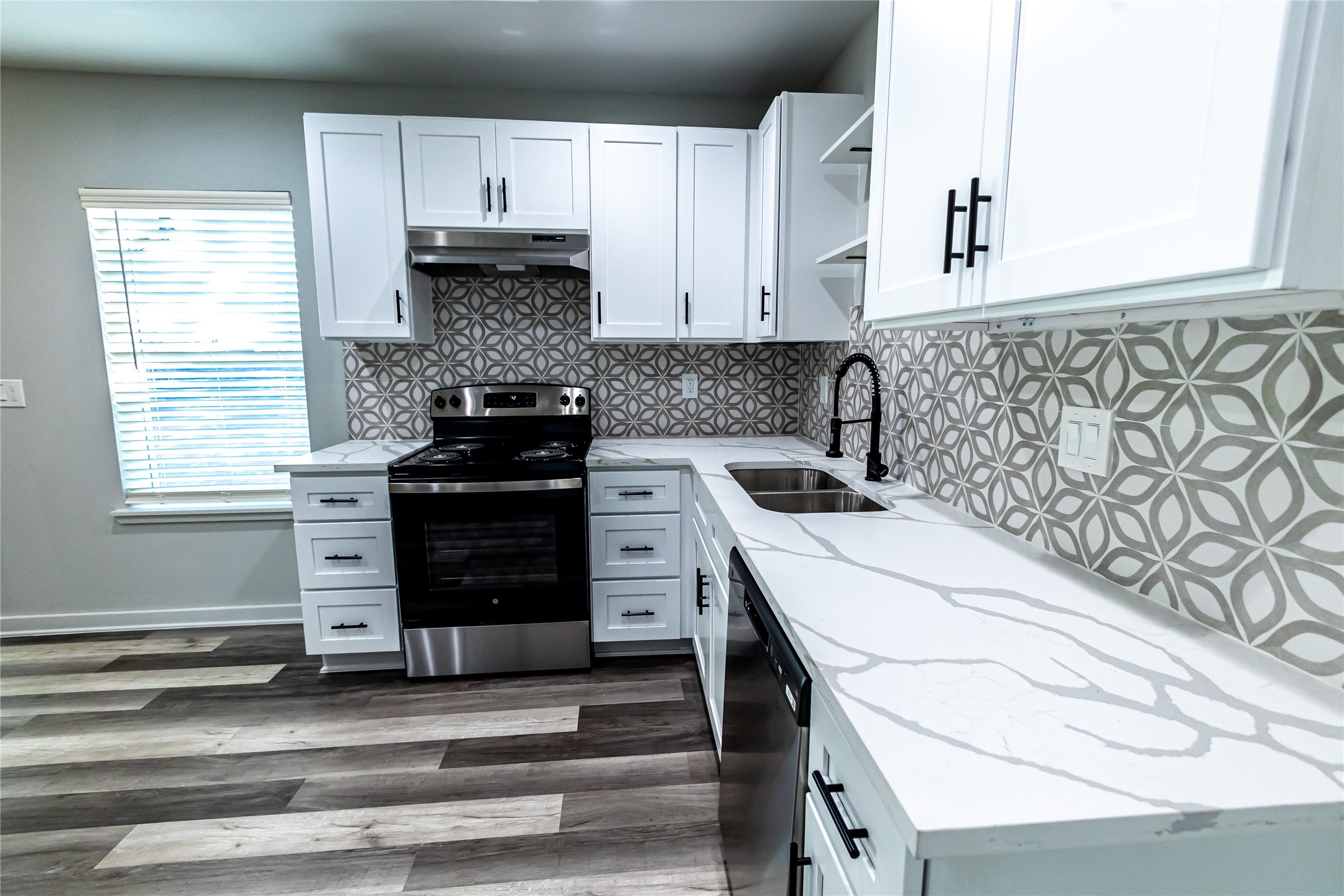 102 Marsden Street, Unit 4 Houston, TX 77011 - Photo 16 of 26 a kitchen with a stove and a white cabinets