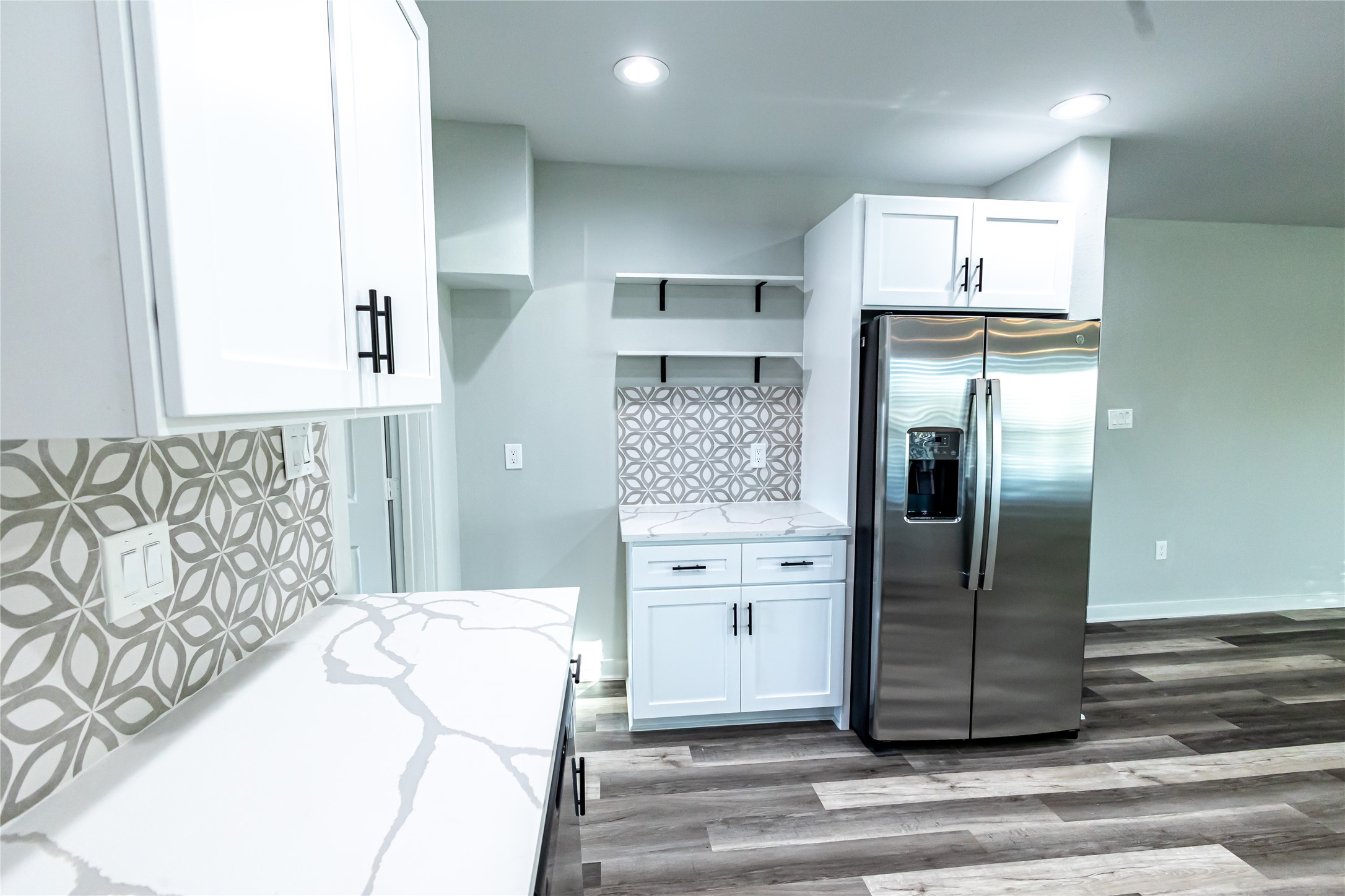 102 Marsden Street, Unit 4 Houston, TX 77011 - Photo 17 of 26 a kitchen with stainless steel appliances kitchen island granite countertop a refrigerator and a stove