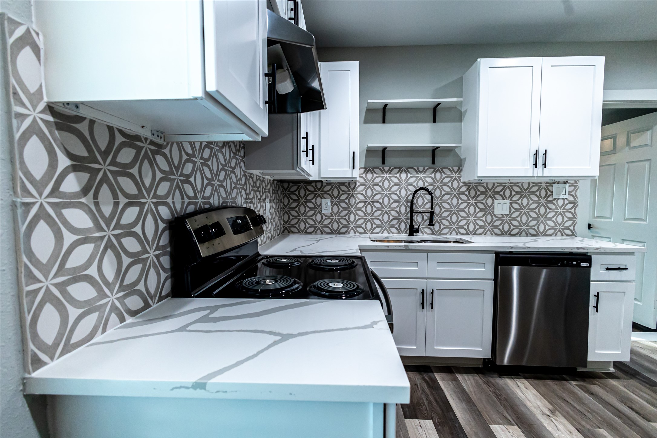 102 Marsden Street, Unit 4 Houston, TX 77011 - Photo 25 of 26 a kitchen with a sink a stove and cabinets