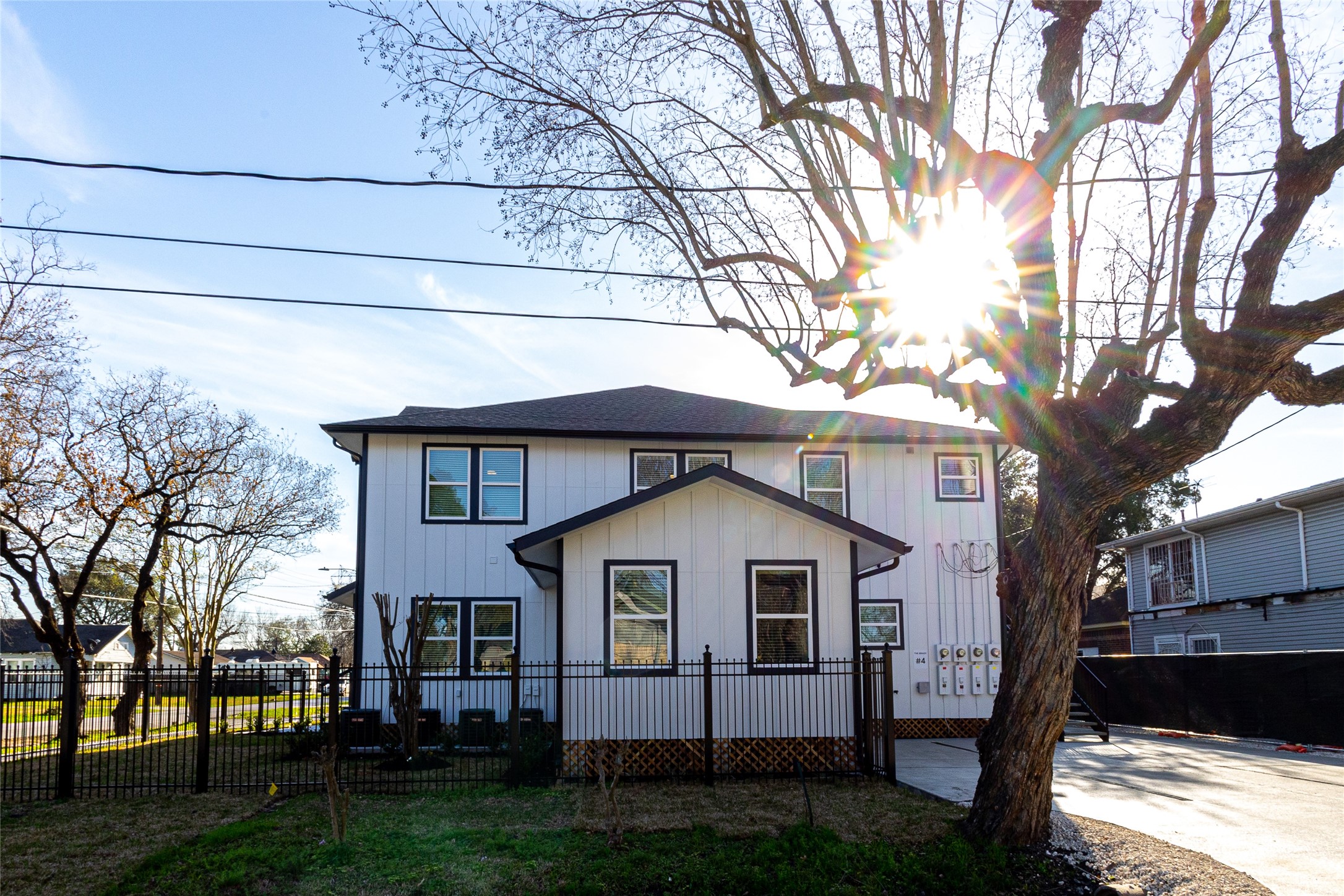 102 Marsden Street, Unit 4 Houston, TX 77011 - Photo 4 of 26 a front view of a house with a yard and garage