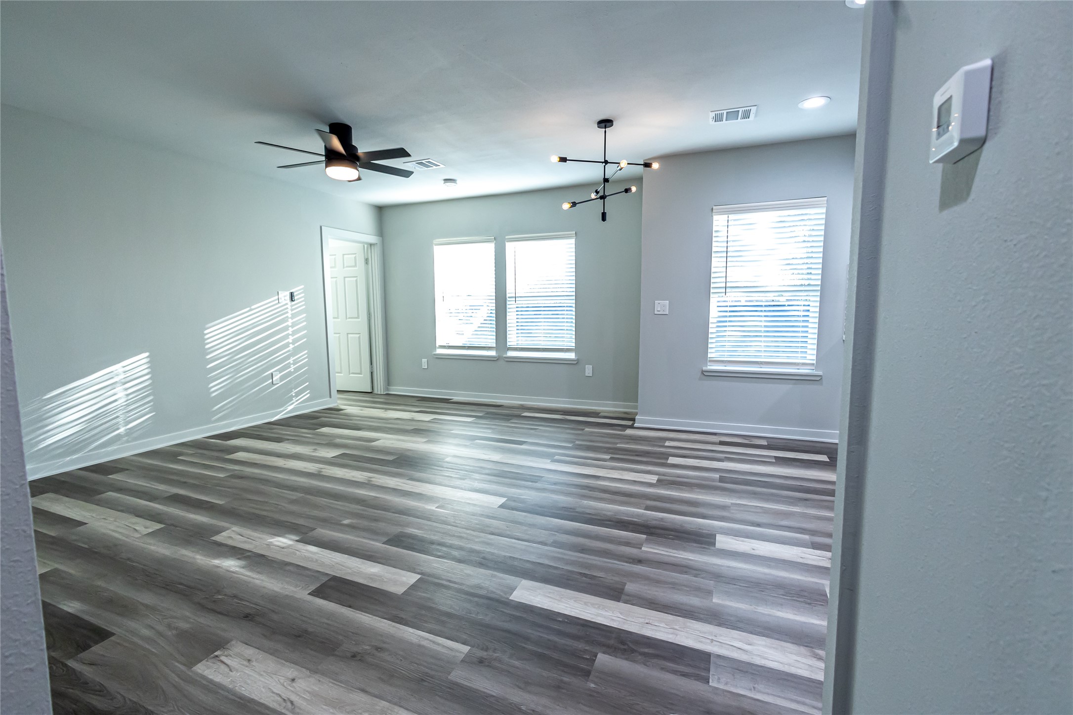102 Marsden Street, Unit 4 Houston, TX 77011 - Photo 9 of 26 a view of empty room with wooden floor and fan