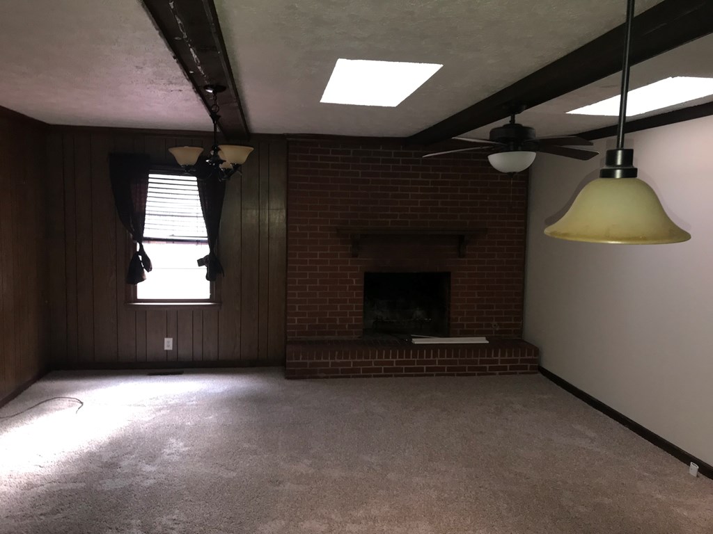 2026 Reese Road Columbus, GA 31907 - Photo 3 of 8 an empty room with a fireplace and windows