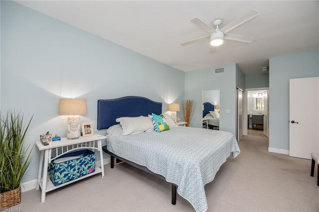 312 Bears Paw Trail Naples, FL 34105 - Photo 13 of 34 a bedroom with a bed and a chandelier