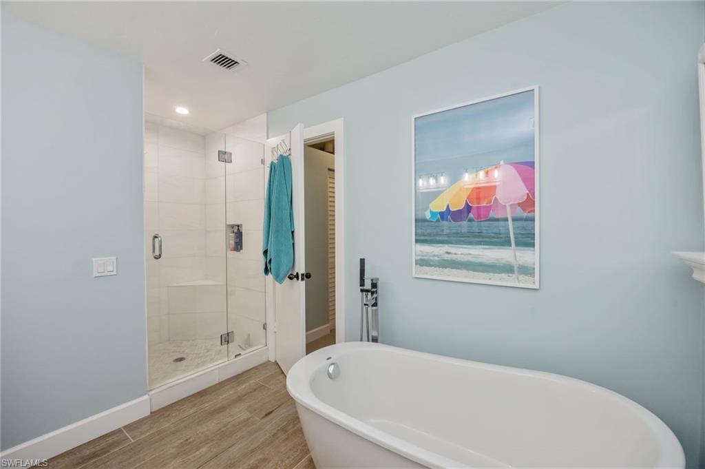 312 Bears Paw Trail Naples, FL 34105 - Photo 16 of 34 a white bath tub sitting next to a bathroom